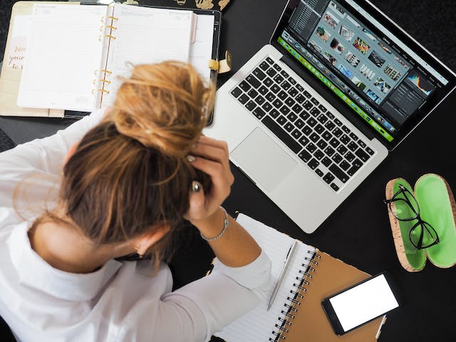 stock image of a person using a laptop with html on the screen